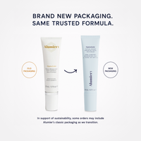 Alumier skincare packaging transition graphic showing the old HydroCalm tube in white and the new HydroCalm tube in pale blue, with text reading 'BRAND NEW PACKAGING. SAME TRUSTED FORMULA.